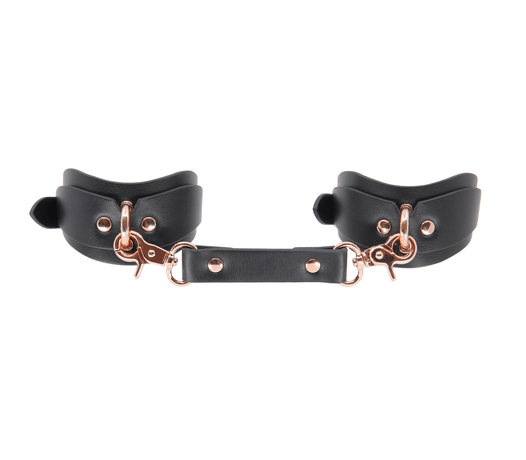 Shaped ankle cuffs with rose gold hardware - premium leather fetish restraints with contoured fit