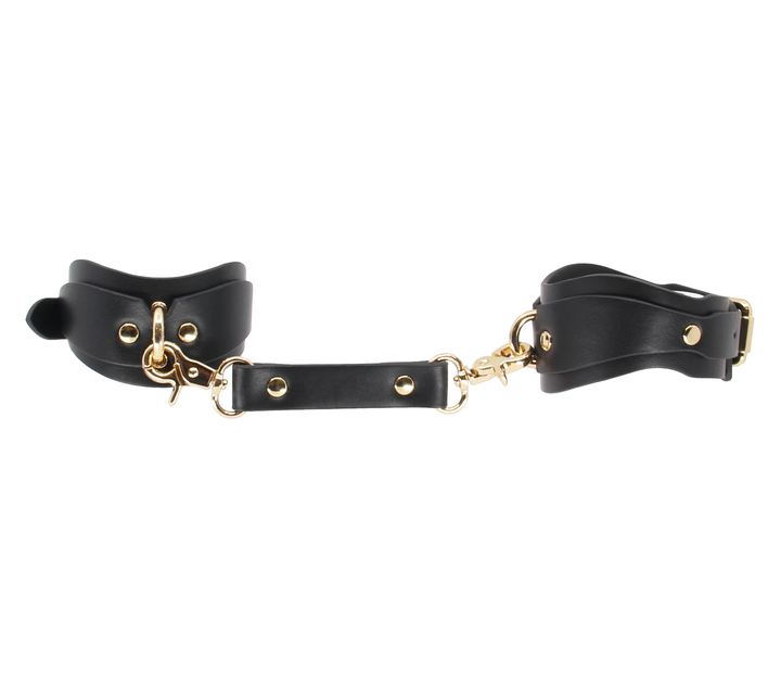 Shaped wrist cuffs with gold hardware detail - premium leather restraints with contoured fit